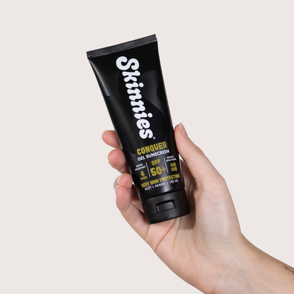 Skinnies CONQUER SPF50+ 100ml in hand